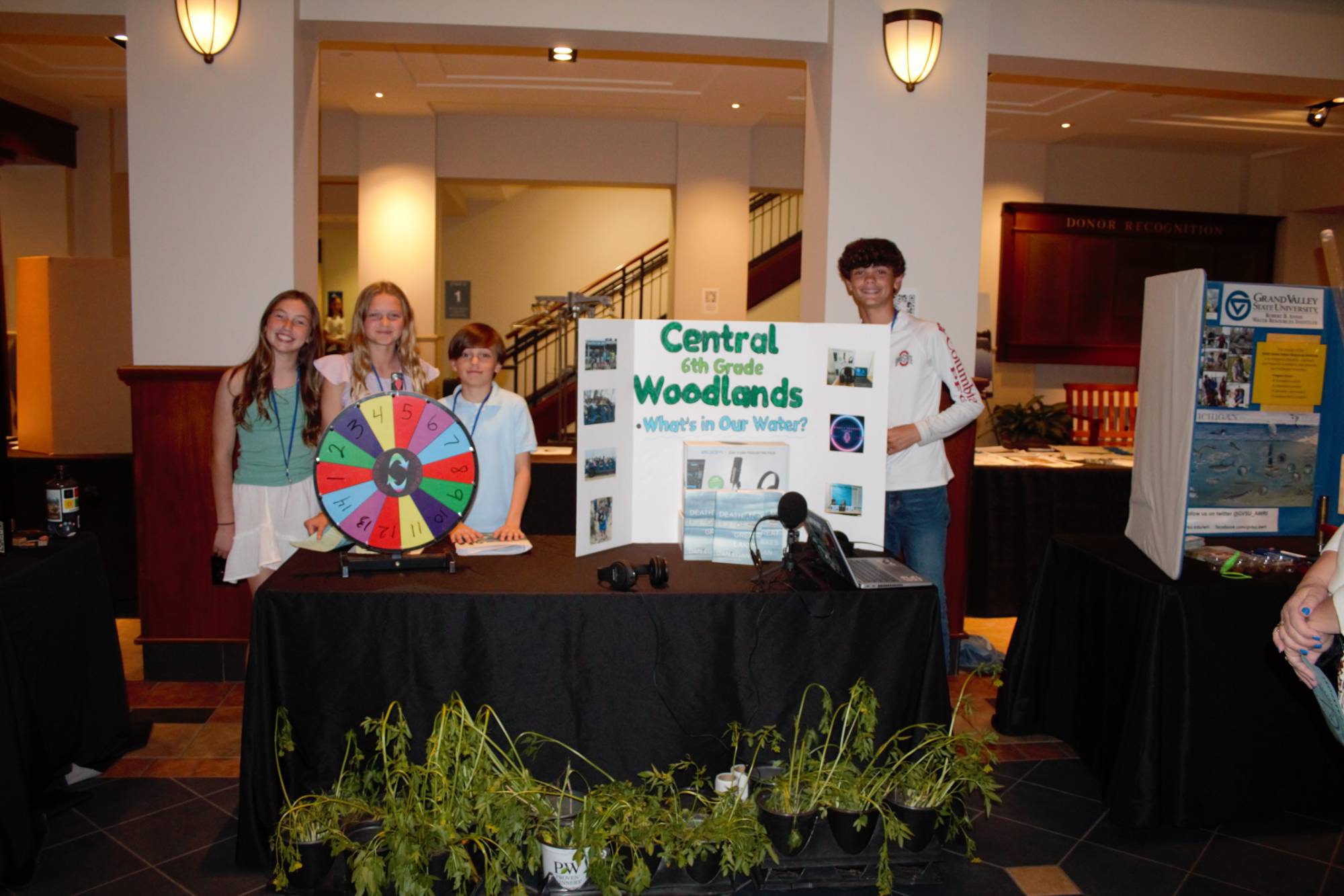 Students standing behind their Showcase table display